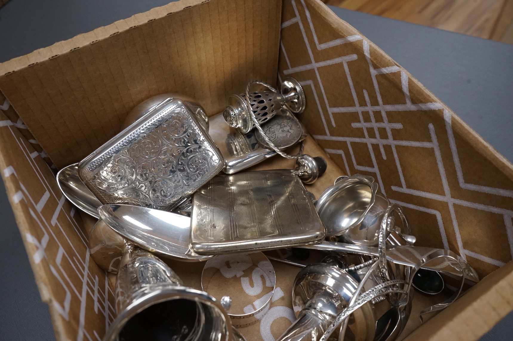 A collection of small silver including an Edwardian Art Nouveau tri-handled pedestal bowl, Birmingham, 1909, height 90mm, a sugar bowl, three cigarette cases, goblet, communion jug, five condiments, three napkin rings, e